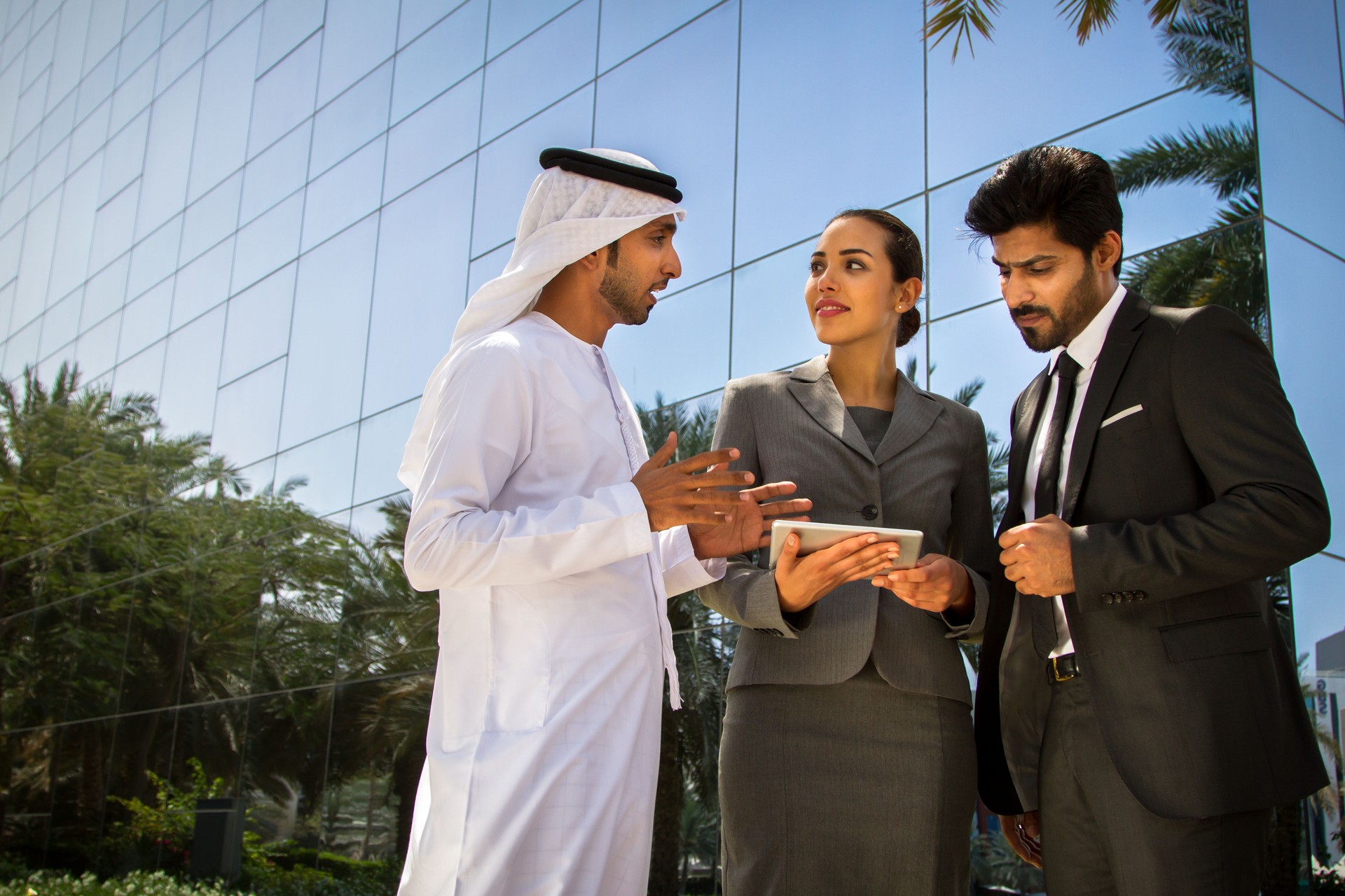 Arab in Kandura talking to his business associates